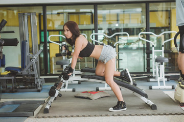 Portrait Of A Sexy Sporty Woman In The Gym With Exercise Equipment.
