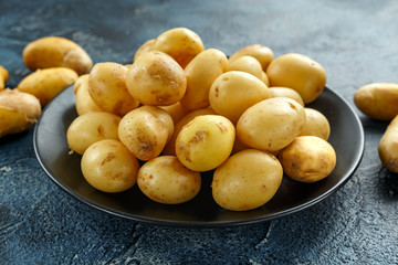 raw baby new potatoes in black plate