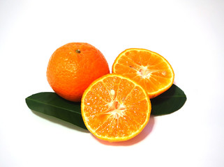 fresh orange fruit on green leaf, white background