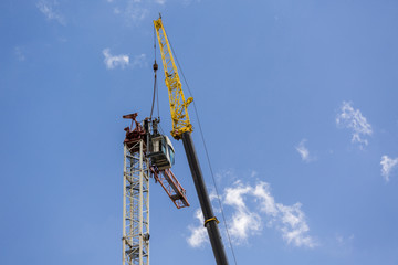 Naklejka premium Disassembly of the tower crane with the help of a super large crane at the construction site