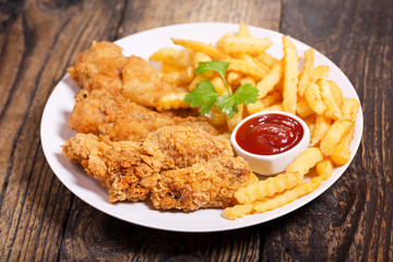 plate of fried chicken with french fries