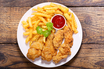 plate of fried chicken with french fries