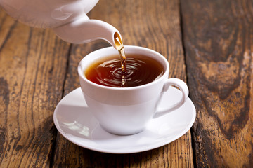 pouring tea into cup
