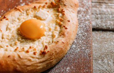 Khachapuri in Adzharian with Adyghe cheese, cheese and yolk. Traditional Caucasian food