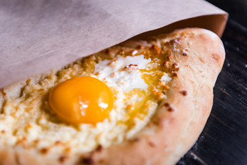 Khachapuri in Adzharian with Adyghe cheese, cheese and yolk. Traditional Caucasian food