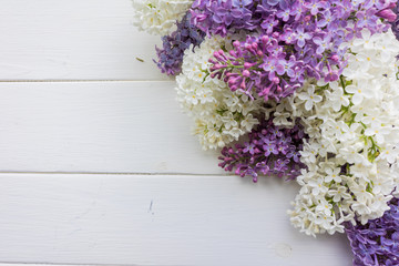 Branch of lilac on a white-painted wooden boards. Top view. Design element for card, banners, print. 