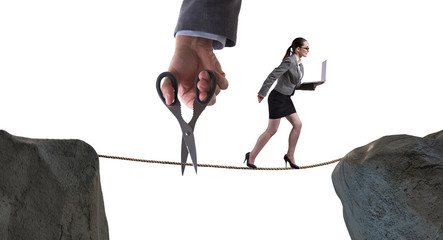 Hand cutting the rope under businesswoman tightrope walker