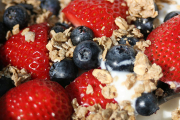 Fresh crunchy granola with nuts, berries and yogurt for healthy breakfast, close up, horizontal