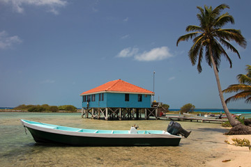 Cabins on stilts on the small island of Tobacco Caye, Belize, Central America