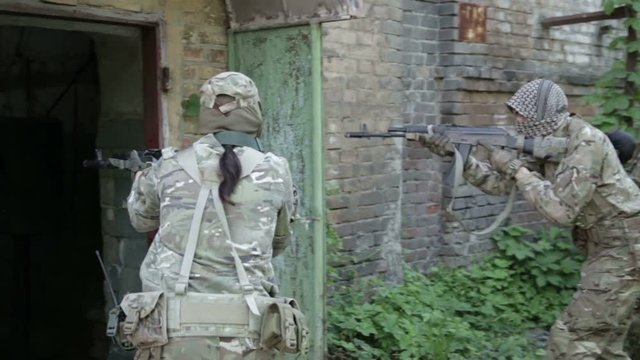 Guerilla partisan warriors operation in urban environment. War battlefield maneuvers training.