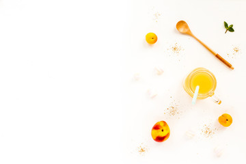 Fresh summer fruit. Peach, nectarine, apricot, mint, peach juice on white background. Top view, flat lay, copy space