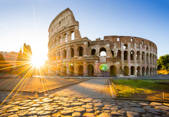 Obraz na płótnie Canvas Colosseum at sunrise, Rome, Italy, Europe. Rome ancient arena of gladiator fights. Rome Colosseum is the best known landmark of Rome and Italy