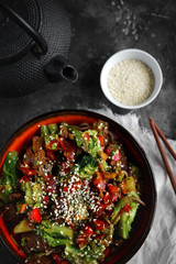 Noodles with vegetables and meat on a dark background, Asian food, Top view, Selective focus