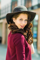 Outdoor portrait of fashionable woman posing in the old city