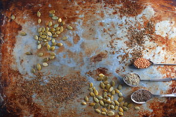 Spices and pumpkin seeds on an old baking sheet, Selective focus, Primitive kitchenalia