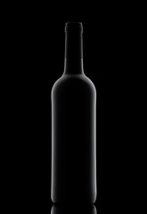 Silhouette of a bottle with wine on a black background