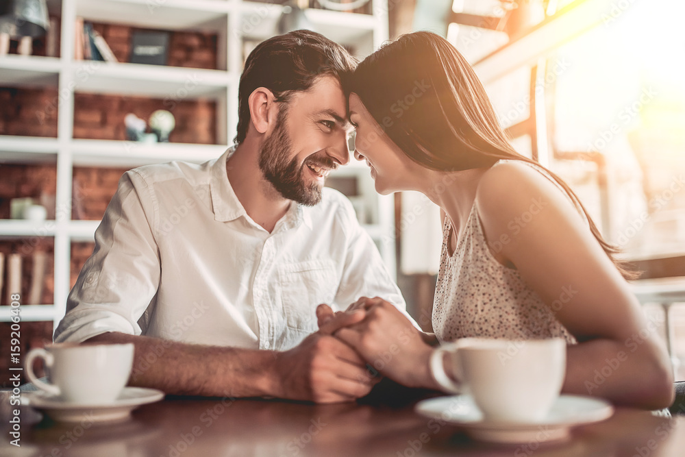 Wall mural Couple in love in cafe