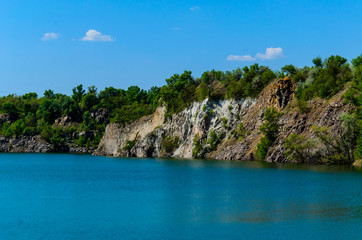 Naklejka na ściany i meble Beautiful lake in abandoned granite quarry