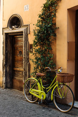 Fototapeta na wymiar Bycicle in old street in Rome, Italy. City bike.