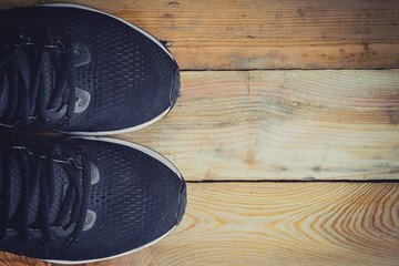 Running shoes on wood background texture with space