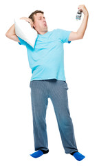 Sleepy man in pajamas with pillow and alarm clock on white background