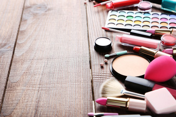 Fototapeta na wymiar Different makeup cosmetics on brown wooden table