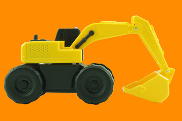 Excavator toy for kid isolated on orange background