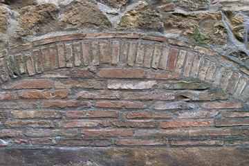 Old brick arc in masonry - mediaeval architecture of a lost place