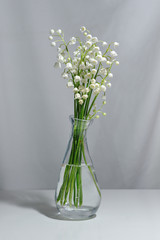 Lily of the valley flowers in a transparent vase