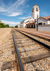 Fototapeta na wymiar railroad tracks lead past a local train depot