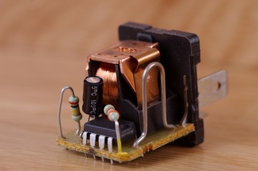 Automotive relay on a wooden table.