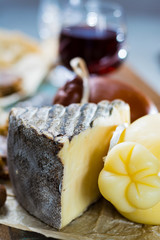 Sweet dessert liqueur wine in glass, hard cheeses Caciocavallo or Provolone, Tomme de Montagne,...