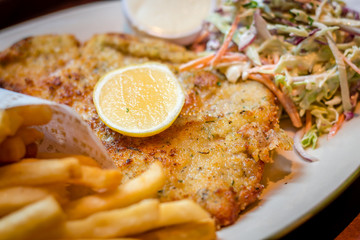 German schnitzel pork chop woth fries and apple coleslaw