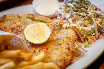 German schnitzel pork chop woth fries and apple coleslaw