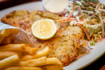 German schnitzel pork chop woth fries and apple coleslaw