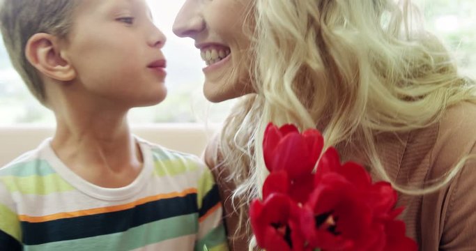 Son offering bunch of flowers to his mother