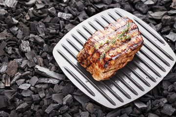 Cooked steak on charcoal