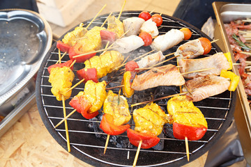 Slices of fish on skewers with vegetables