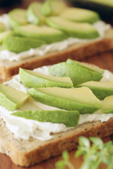 Avocado and cream cheese on wholemeal bread - shallow dof