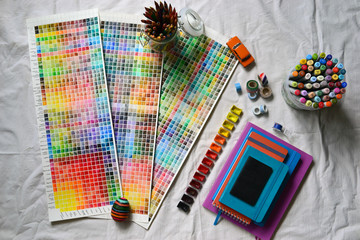 A composition of artistic accessories and a watercolor palette