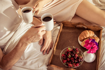 Couple having breakfast in bed