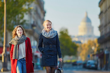 Two young girls walking together in Paris