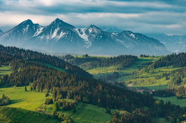 Fototapeta na wymiar Beautiful spring panorama over Spisz highland to snowy Tatra mountains in the morning, Poland
