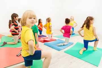 Boy standing on knee during gymnastic activity