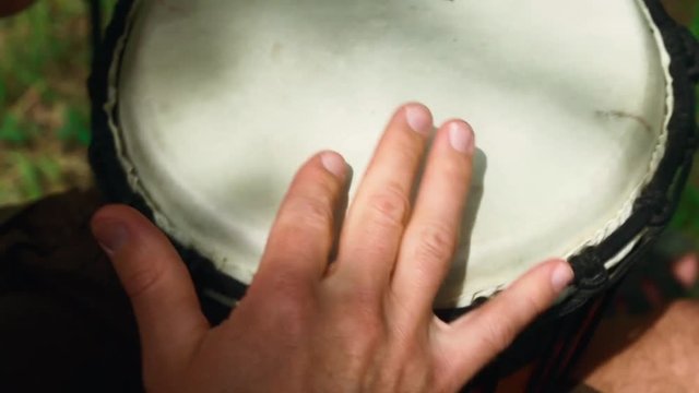tom-tom ; a tall narrow drum