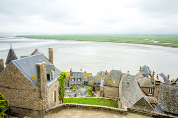 View from the ambasady on the old town and the ocean in Mont Saint Michel in France - obrazy, fototapety, plakaty