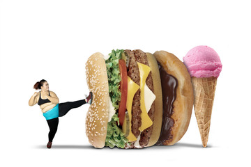Fat woman kicks burger and ice cream