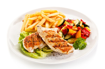 Grilled chicken fillet with french fries on white background