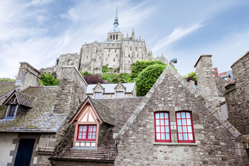 Naklejka premium Ancient buildings of the old town on the famous Mont Saint Michel island in France