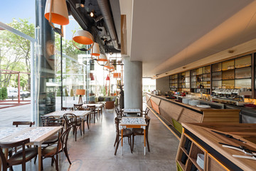 Interior of a modern urban restaurant with concrete floor